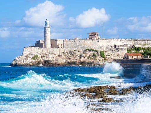 El Morro castle in Havana with sea waves crashing on the Malecon seawall
